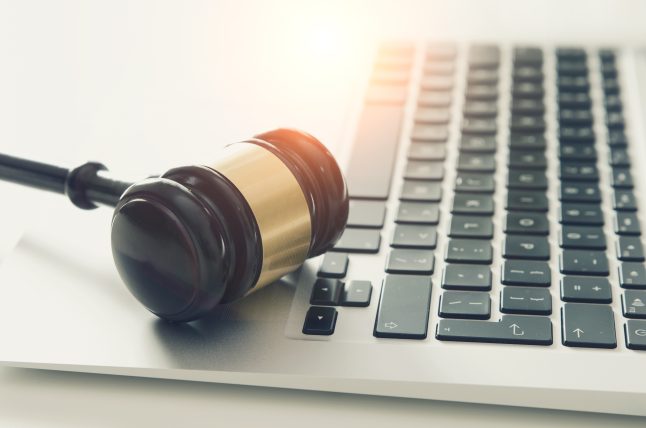 Wooden gavel on laptop keyboard